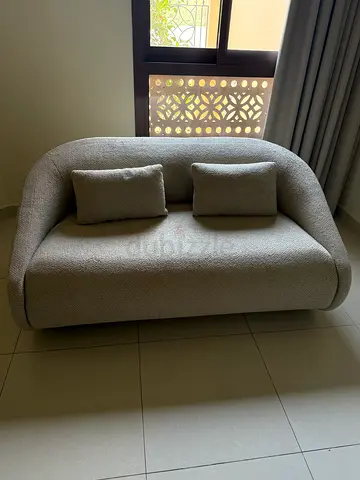 Beige Two-Seater Curved Sofa bed in excellent condition