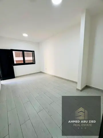 First-tenant apartment for rent in Al Nuaimiya 1, Ajman, near Gulfa Bridge, featuring 2 bedrooms and a hall, spacious layout, 2 bathrooms, balcony wi