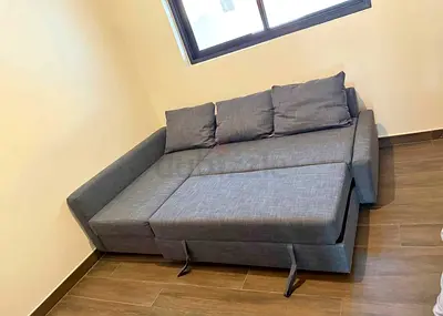 Grey fabric sofa bed with storage