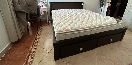queen-size bed with mattress and two built-in storage drawers.
