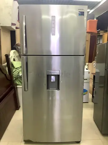 Large stainless steel side-by-side refrigerator with water dispenser - used