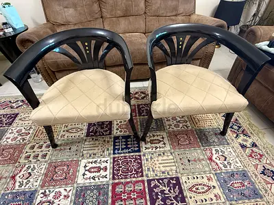Pair of classic wooden dining chairs with beige upholstered seats
