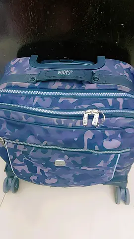 Blue camo carry-on backpack with wheels (hard-topped handle)