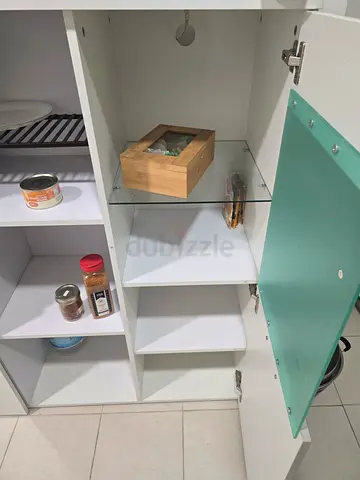 White kitchen cabinet with glass door and open shelves