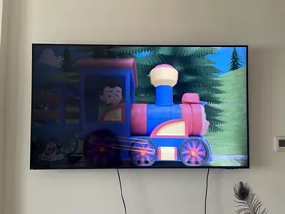 Samsung 55-inch LED Smart TV mounted on wall - Good condition