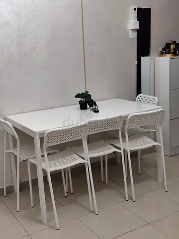 White dining table with 4 matching chairs - simple modern set