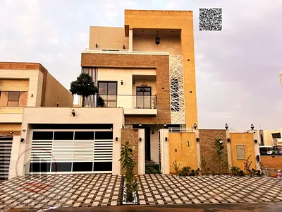 Villa for sale in Ajman, Al Helio area, 5 master bedrooms, a living room, a hall, and a maid's room. Freehold for all nationalities, with the possibil