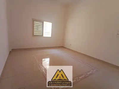 Spacious studio apartment with a semi-detached kitchen in Rawda 2, close to all services and main roads, with easy access to Dubai and Sharjah.