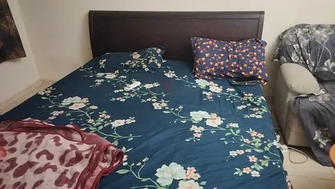 King bed frame with mattress and floral bedsheet - used