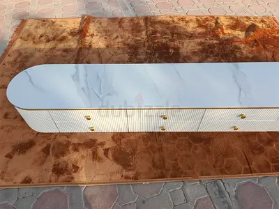 Long white marble-top TV cabinet with gold handles - modern low console