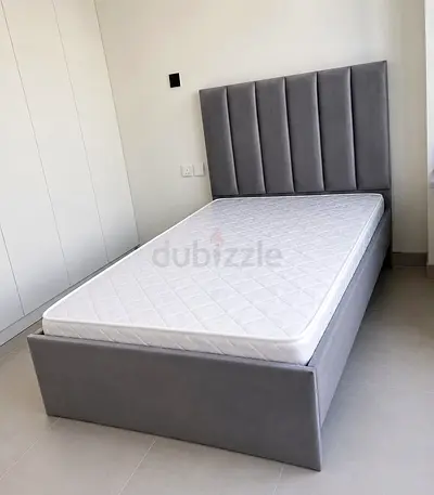 Single grey upholstered bed frame with mattress - modern vertical panel headboard