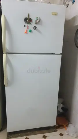 Used white top-freezer refrigerator in good working condition
