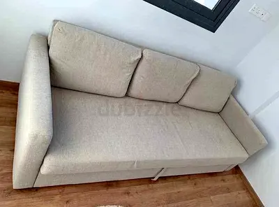 Comfortable beige sofa bed with storage
