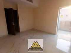 Two-bedroom apartment for annual rent in Al Alia, Ajman. Balcony, 2 bathrooms, central AC, near Shei