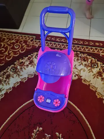 Used pink/purple push walker/ride-on baby walker with handle - good condition