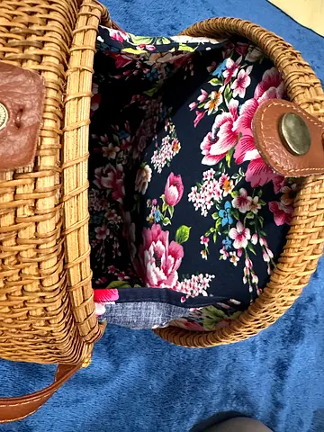 Woven rattan crossbody basket bag with floral fabric lining