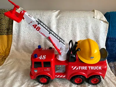 Child’s Red Fire Truck Ride-On Toy with Extendable Ladder and Helmet