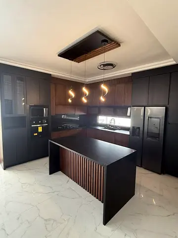 Modern dark wood kitchen with island — complete built-in units