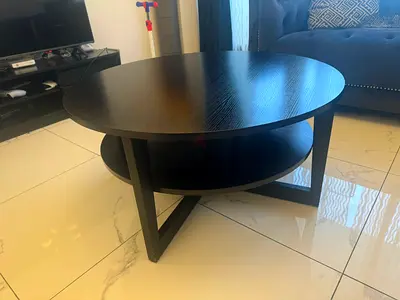 Round dark wood coffee table with lower shelf - good condition
