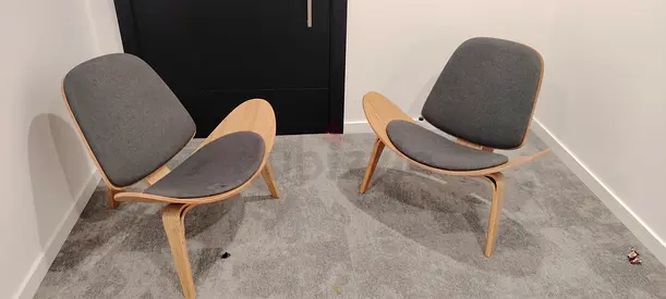 Pair of mid-century modern lounge chairs with grey cushions