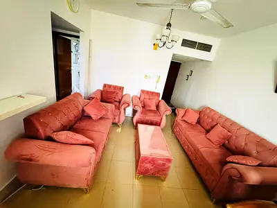 4-piece pink velvet sofa set with matching ottoman — good condition