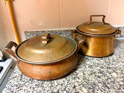 Pair of vintage hammered copper cooking pots with lids - used