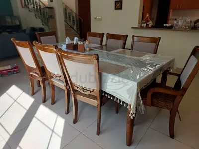 Solid wood 8-seater dining table with chairs - good condition