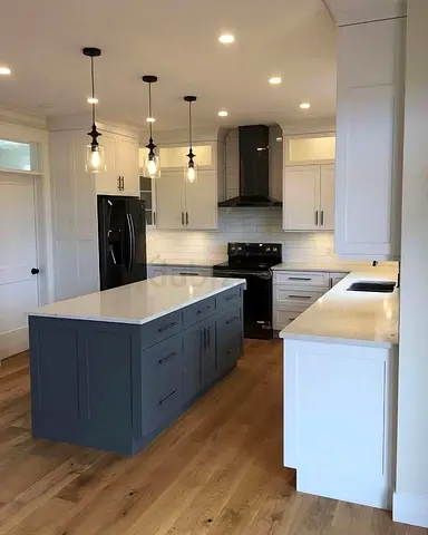 Modern kitchen with center island, white cabinets and gray island