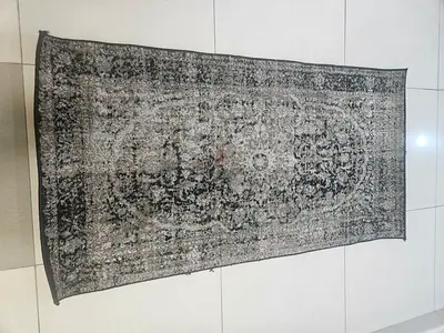 Used Persian-style rectangular rug in neutral black/grey tones - good condition