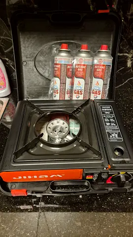Portable butane gas stove with carrying case and fuel canisters