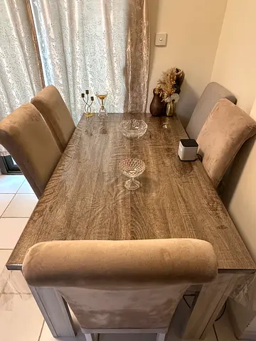 Wood-look dining table with 5 upholstered beige chairs - excellent condition