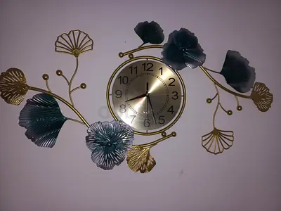Decorative metal wall clock with floral design - gold & teal