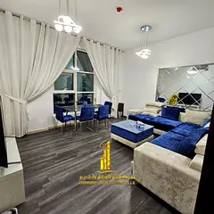 Luxury apartment, second occupancy, two bedrooms, living room, and open balcony. Ajman City Tower. F