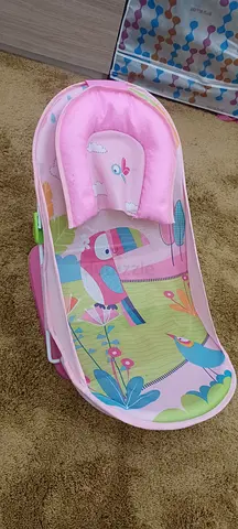 Pink baby bathing chair /portable rocker with soft headrest - gently used