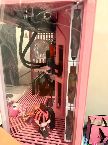 Pink open-frame PC case with tempered glass side — used