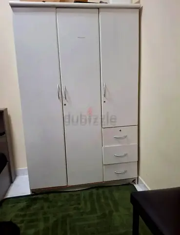 URGENT Selling ! White 3-door wardrobe with 3 drawers in good condition.Selling only at AED 100