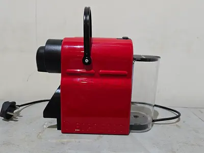 Compact red capsule coffee machine (used) - works fine
