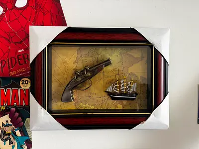 vintage 3d painting with gun and pirate ship model inside