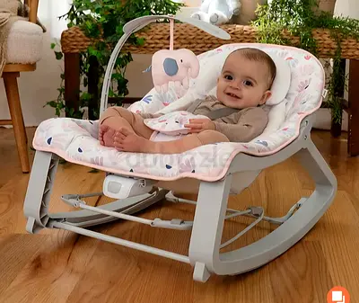 Comfortable baby rocker/bouncer with soft cushion and toy bar - gently used