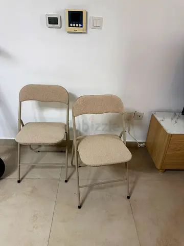 Pair of beige folding chairs - good condition