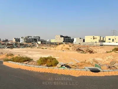 Land for sale in Al Helio 2 – Ajman | 3 independent villa plots in a prime location facing the street | Area 280 m² per plot | Price AED 715,000 inclu