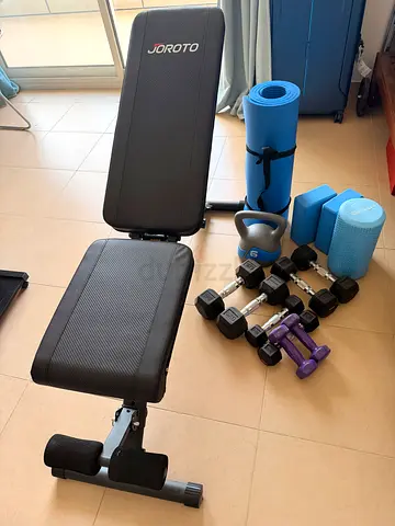 Adjustable workout bench with dumbbells, kettlebell and yoga mats - good condition
