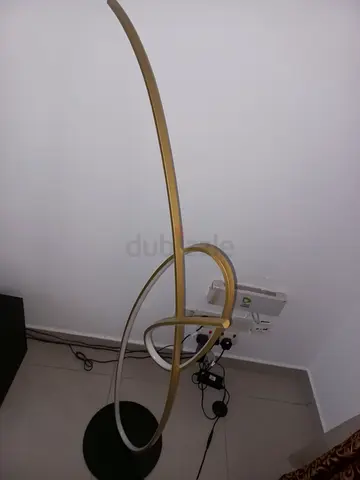 Modern gold LED floor lamp with curved ring design
