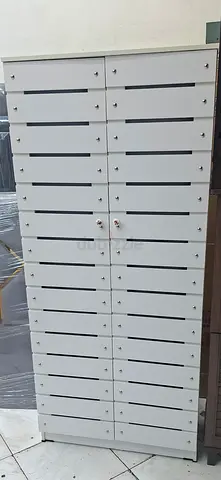Tall white multi-compartment storage cabinet with 30 lockable cubbies