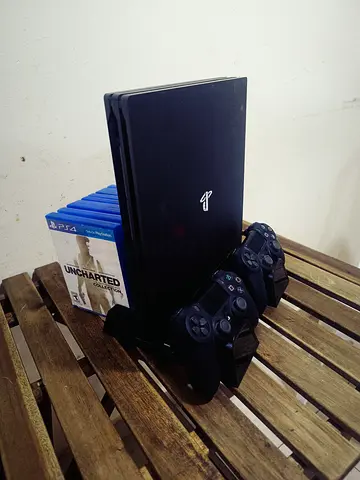 PS4 1 TB Slim with 2 original console + silicone protection cover + 9 amazing games + console stand.