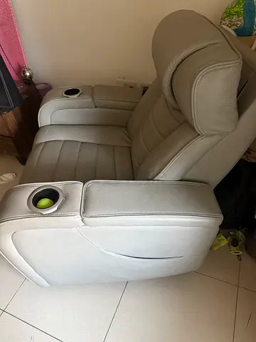 Light grey leather reclining cinema-style armchair with cup holders