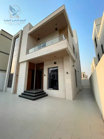 Brand new villa for annual rent in Al Bahia, Ajman. Central air conditioning, luxurious finishes, spacious areas. Features a modern design, spacious