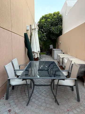Outdoor glass-top dining table with 4  chairs - good condition.