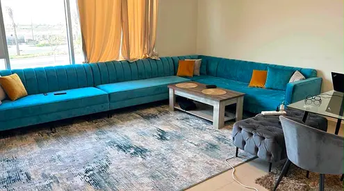 Large L-shaped teal velvet sectional sofa with cushions - good condition