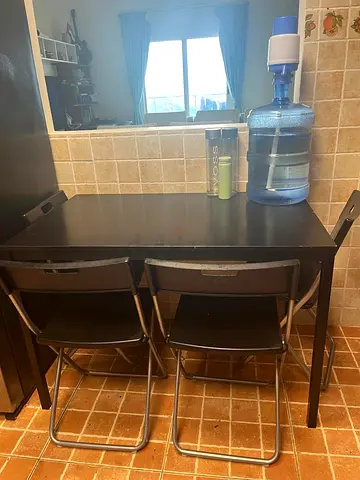 Compact black dining table with 4 folding chairs
